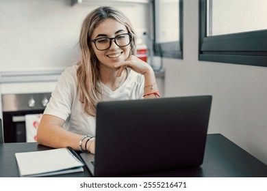 Happy young blonde business woman entrepreneur using computer looking at screen working in internet sit at office desk, smiling millennial female professional employee typing email on laptop at work - Powered by Shutterstock