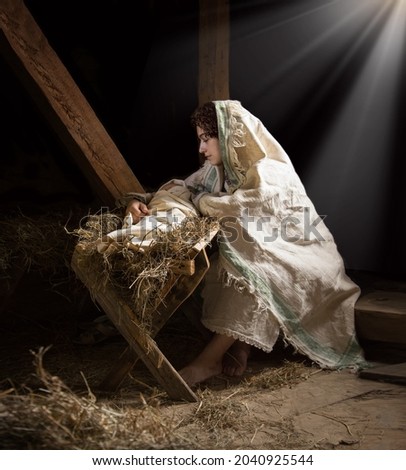 Happy young boy cradle sleep life symbol star light white cloth greet card text space. Dark black stable barn cave hay straw live scene cute new parent merry Lord messiah noel eve love joy lady hand