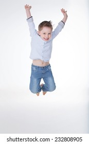 Happy Young Boy Jumping And Laughing