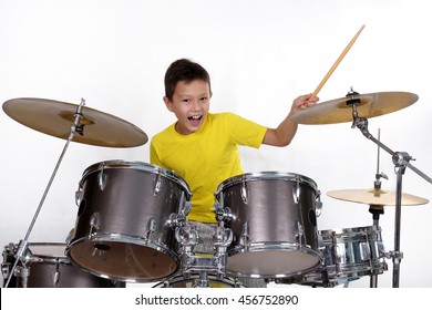 Happy Young Boy Playing Drums