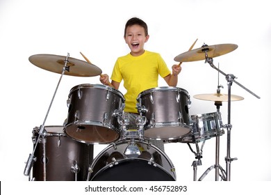 Happy young boy playing drums