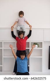 happy young boys having fun and posing line up piggyback in new modern home - Shutterstock ID 642632575