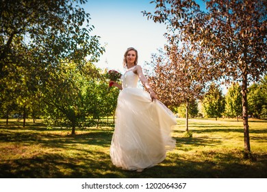 Happy Young Bride On Autumn Forest Background.