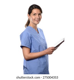 Happy Young Brunette Nurse Or Doctor In Blue Uniform Smiling While Using A Thin Wireless PC Tablet Connected To Internet, Side Portrait Isolated On White