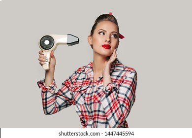 Happy Young Brunette Woman With Hair Dryer. Pin-up Retro Style