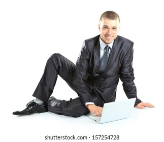 Happy young business man working on a laptop, isolated on white background