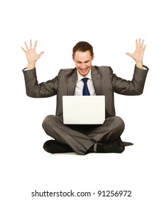Happy young business man working on a laptop, isolated against white background