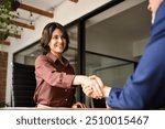 Happy young business woman bank manager handshaking client at meeting. Smiling female hr hiring recruit at job interview, insurance agent, lawyer making contract deal at work with business handshake.