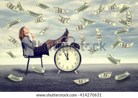 Happy young business woman sitting on a chair under a money rain .