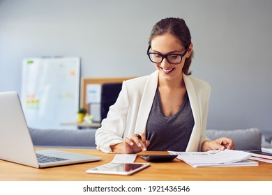 Happy Young Business Woman Working From Home Using Calculator