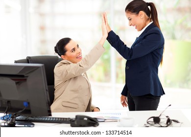 Happy Young Business Women Doing High Five In Office