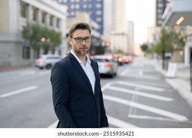 Happy young businessman in casual attire looking at camera. Smiling 40 year old mature confident professional manager, confident businessman investor looking at camera. Businessman on the street - Powered by Shutterstock