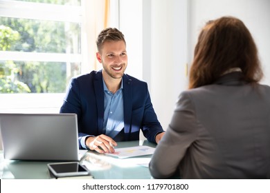 Happy Young Businessman Looking At Candidate During Job Interview