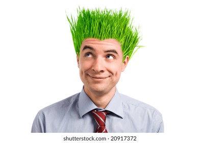 Happy young businessman looking up at his new vivid green grass hair. Green business concept