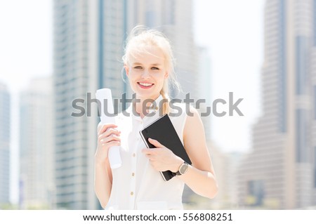 Happy young businesswoman in the city