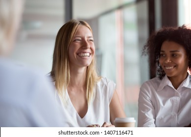 Happy young businesswoman coach mentor leader laughing at funny joke at group business meeting, joyful smiling millennial lady having fun with diverse corporate team people engaged in talking at work - Shutterstock ID 1407116471