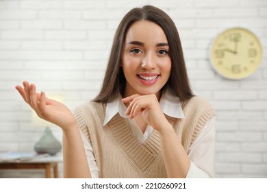 Happy Young Businesswoman Conducting Webinar In Room