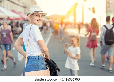 Happy Young Caucasian Bald Woman In Hat And Casual Clothes Enjoying Life After Surviving Breast Cancer. Portrait Of Beautiful Hairless Girl Smiling During Walk At City Street With After Curing Disease