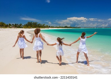 Happy Young Caucasian Family Having Fun Together Outdoor By Tropical Ocean Walking On Beach For Leisure Luxury Travel Summer Escape