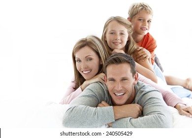 Happy Young Caucasian Family Making A Human Pyramid