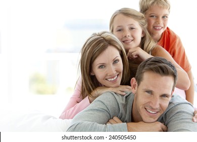 Happy Young Caucasian Family Making A Human Pyramid