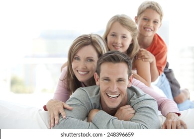 Happy Young Caucasian Family Making A Human Pyramid