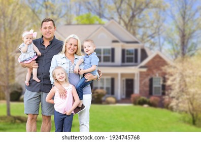 Happy Young Caucasian Family Outside  In Front of Their New Home.