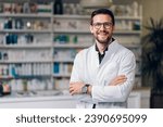 A happy young Caucasian pharmacy shop owner, standing in their newly-opened pharmacy shop. Wearing a white coat, glasses and a watch. The stature reflects success and high hopes for their business.