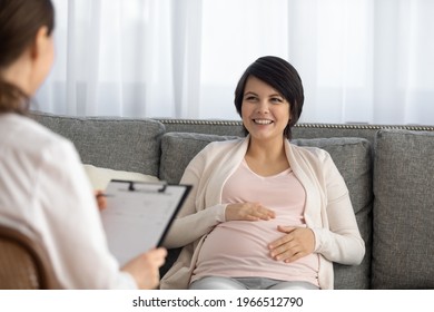 Happy Young Caucasian Pregnant Woman Talk Consult With Gynecologist In Private Clinic Or Hospital. Smiling Lady Enjoy Pregnancy Have Checkup With Doctor. Healthcare, Maternity, Medicine Concept.