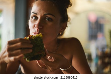 Happy Young Caucasian Suntanned Beautiful Woman Eating Mexican Spinach Wrap Vegetables Green Rolls. Healthy Food