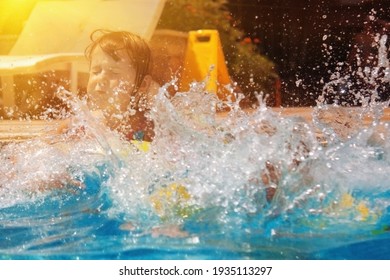 Happy young child girl enjoying summer vacation, jumping  outdoors into the pool.