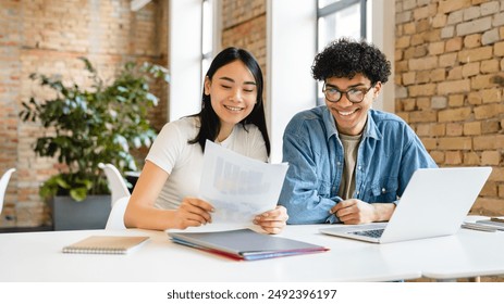 Happy young colleagues partners college students classmates friends having discussion working studding doing home work create start up together at the office desk in coworking area. Teamwork concept - Powered by Shutterstock