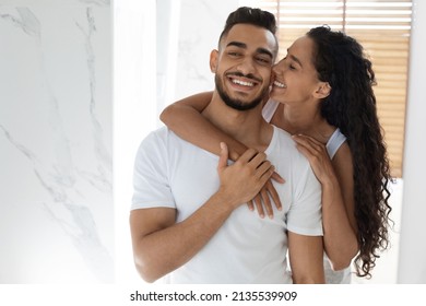 Happy Young Couple In Bathroom Having Fun Together While Getting Ready In The Morning, Romantic Middle Eastern Spouses Embracing And Laughing, Loving Woman Kissing Her Husband, Copy Space - Powered by Shutterstock