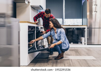 Happy Young Couple Buying Household Appliances In Store.