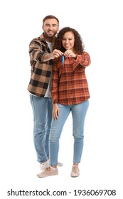 Happy Young Couple With Car Key On White Background