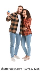 Happy Young Couple With Car Key On White Background