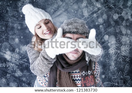 Happy young couple   covering  snow background.fooling around. Snowy card.