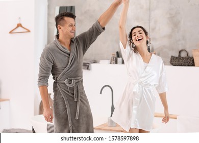 Happy Young Couple Dancing In Bathroom At Home