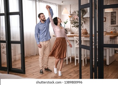 Happy Young Couple Dancing At Home