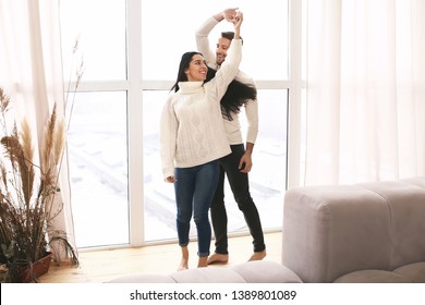 Happy Young Couple Dancing At Home