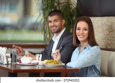 Happy Young Couple Dining In A Restaurant