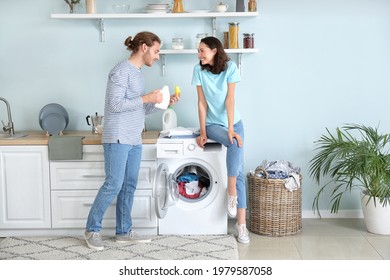 Happy Young Couple Doing Laundry At Home