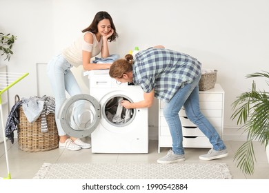 Happy Young Couple Doing Laundry At Home