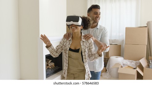 Happy Young Couple Doing Virtual Tour In New Apartment