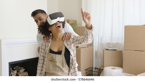 Happy Young Couple Doing Virtual Tour In New Apartment