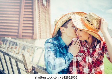 Happy Young Couple Dressed In A Cowboy Style Hugging And Having A Good Time In The Park