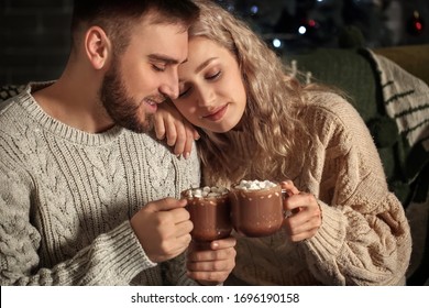 Happy young couple drinking hot cocoa at home - Powered by Shutterstock