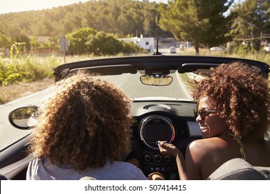 Happy young couple driving in an open top car, Ibiza, Spain - Powered by Shutterstock