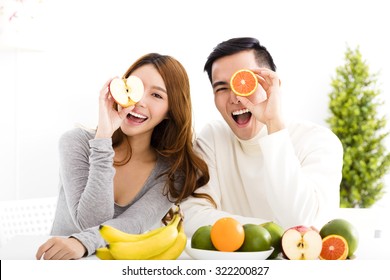 Happy Young Couple Eating Fruit And Healthy Food 