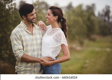 Happy young couple embracing at olive farm - Powered by Shutterstock